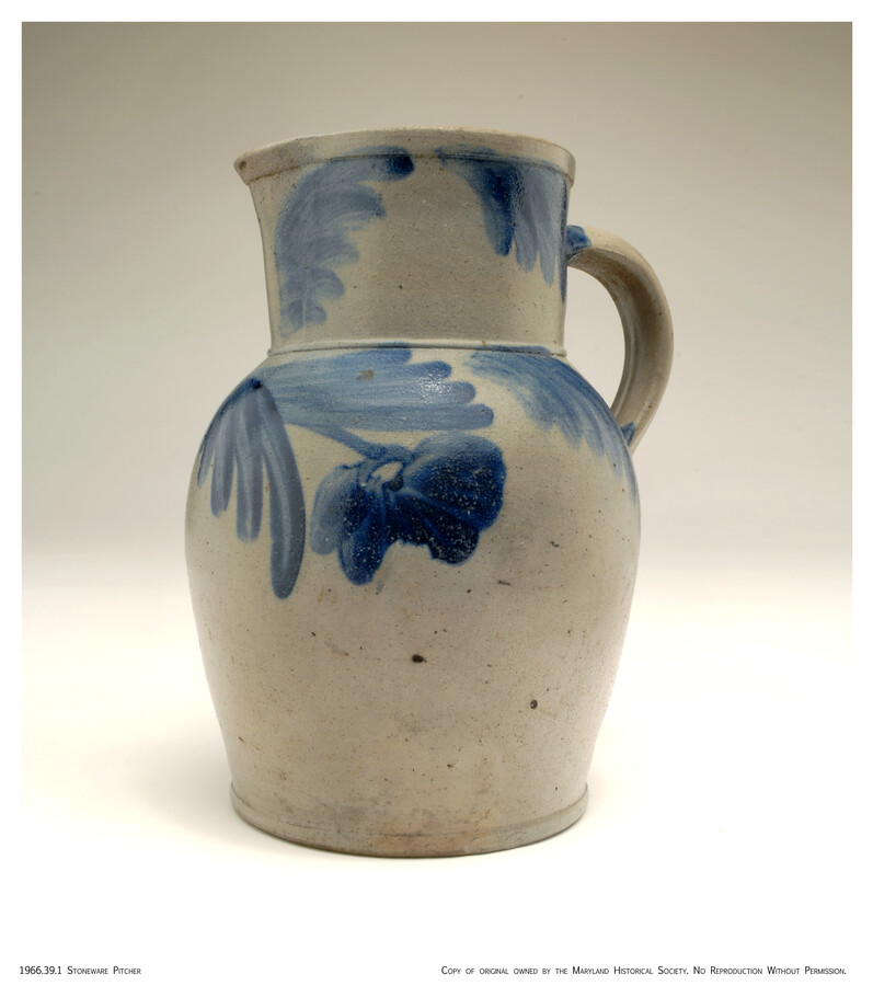 Salt-glazed stoneware pitcher decorated with elaborate blue flower and leaf motif. Incised under handle with 'A Wepfield/ 1870' /three links, Independent Order of Odd Fellows emblem. Made at Maulden Perine's Baltimore Street Pottery and stood in the window of Bowers Pharmacy, 1001 W. Baltimore St. next to J. B. Cook.