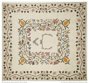 Appliqued and stuffed quilt made in Montgomery County, Maryland. The quilt features a central appliqued floral motif surrounded by an interior appliqued floral vine border with pineapples at each corner on a plain white background. The quilt has a wide appliqued grapevine border.