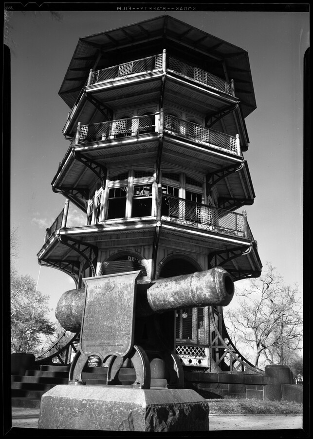 A side view of a cannon from the War of 1812 in front of the Patterson Park Pagoda in Baltimore, Maryland. The Pagoda, designed in 1890 by Charles H. Latrobe (1833-1902), was originally known as the Observatory.