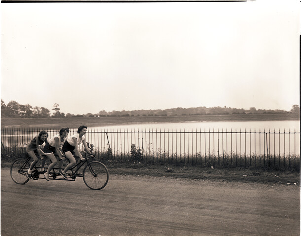 Women on three-seater bicycle — 1955-07-09