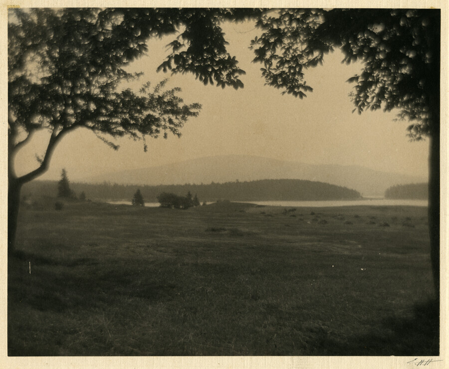 A landscape of fields, lakes, and hills in Mount Desert, Maine. Part of a series of photographs on "places" by the Baltimore, Maryland, photographer Emily Spencer Hayden.